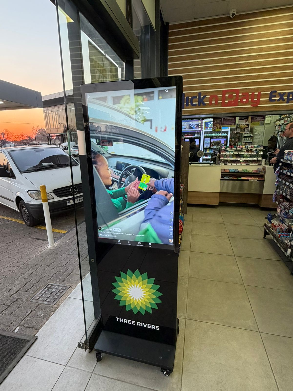 Freestanding digital signage screen at a filling station